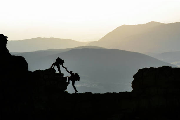 istock struggle and cooperation of climbers in the high mountains 1211500802
