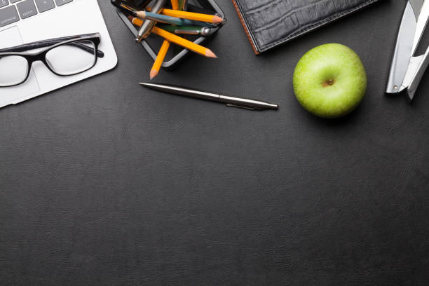 istock Office desk table with laptop, supplies and apple 1211502181