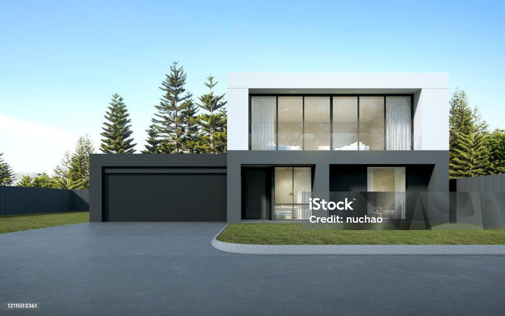 Perspective of  black and white modern luxury house with green lawn yard on tree background, Idea of minimal architecture with garage door. 3D rendering House Stock Photo