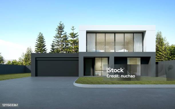 Perspective Of Black And White Modern Luxury House With Green Lawn Yard On Tree Background Idea Of Minimal Architecture With Garage Door 3d Rendering Stock Photo - Download Image Now