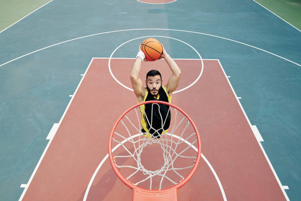 istock Player throwing ball in basket 1211503526