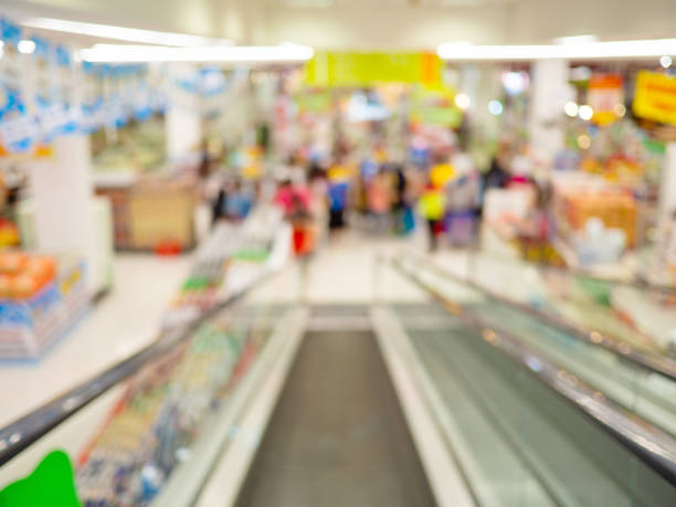 istock Escalator inside supermarket, Blurred shopping mall  and retails store interior for background, shopping concept 1211504051