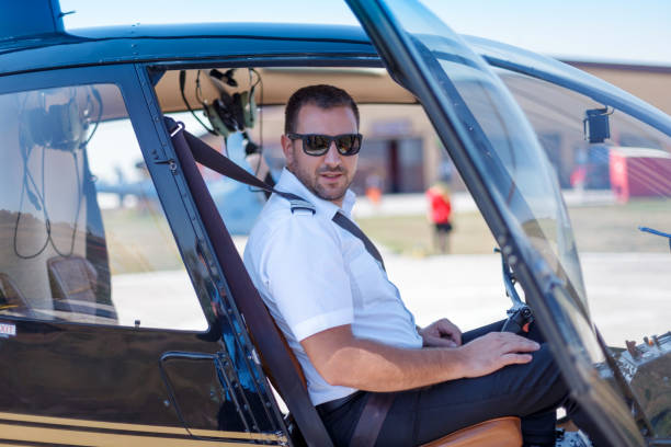 istock Helicopter pilot sitting in cockpit with fastened seatbelt 1211504196