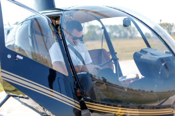 istock Pilot in helicopter cockpit checking equipment 1211504199