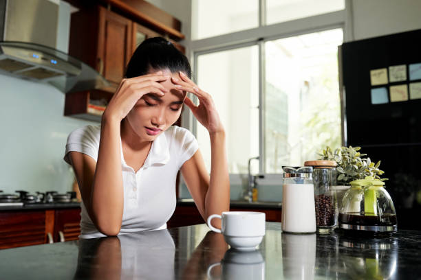 istock Sleepy young woman in kitchen 1211504266