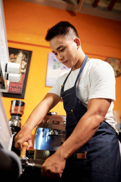 istock Barista brewing coffee 1211504284