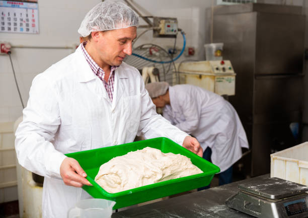 Baker preparing dough for rolling