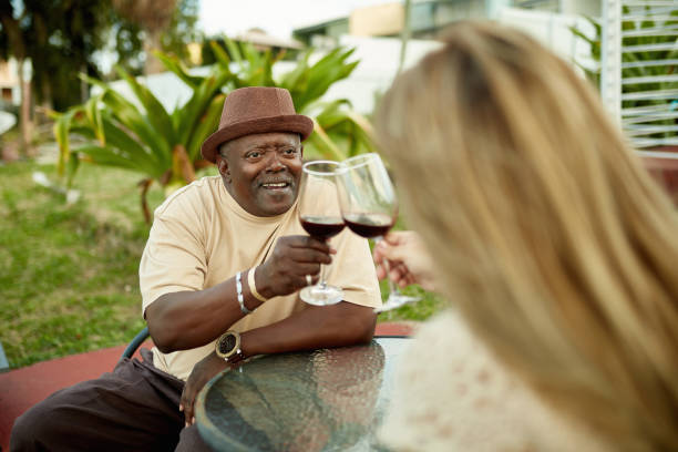 istock Smiling Senior African-American Man Toasting with Wine 1211506551