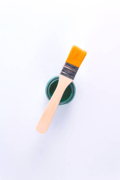 istock Brush at the top of paint can. 1211507243