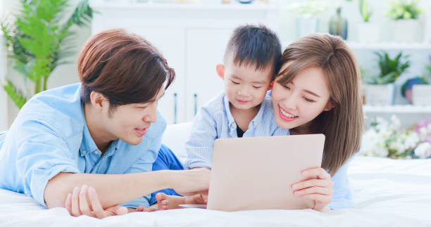 istock Parent play laptop with child 1211513500
