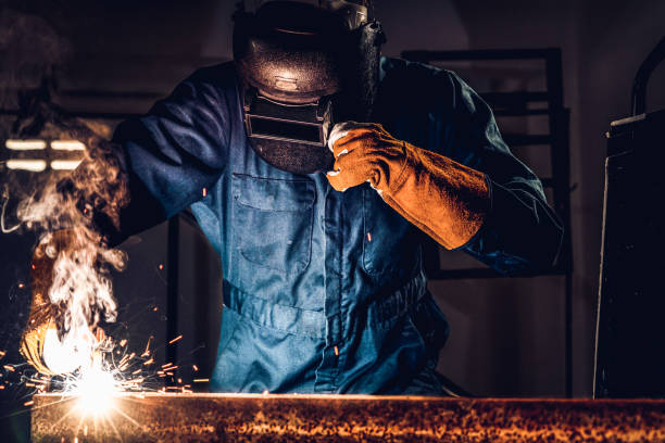 istock Metal welder working with arc welding machine. 1211513588
