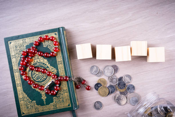 Flat lay composition of Qoran and Tasbih Flat lay composition of Qoran and Tasbih (prayer beads beads). The words on the Qoran is arabic character which means the Holy Qoran kaabah stock pictures, royalty-free photos & images