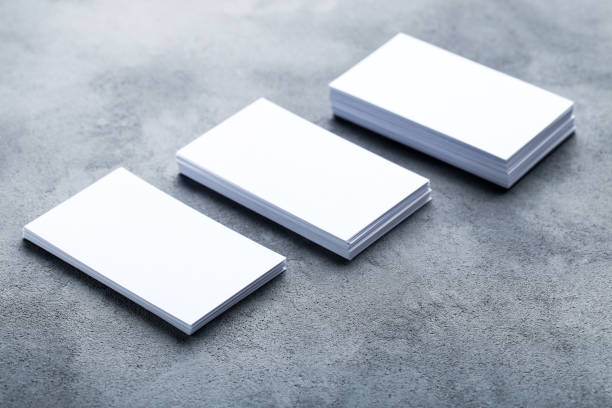 istock Blank business cards on gray background 1211516249
