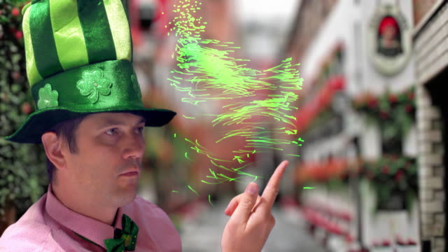 Magician in green hat showing magic tricks on St's Patrick Day