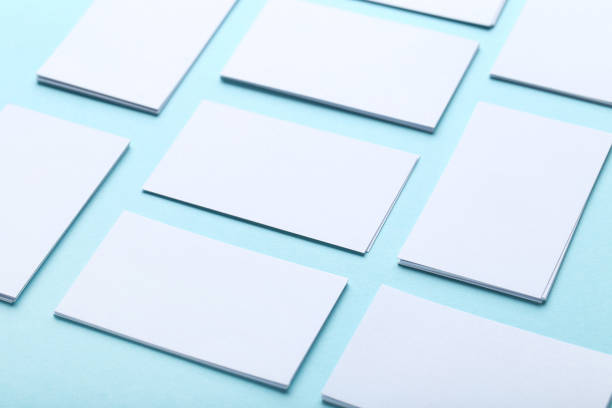 istock Blank business cards on blue background 1211517269