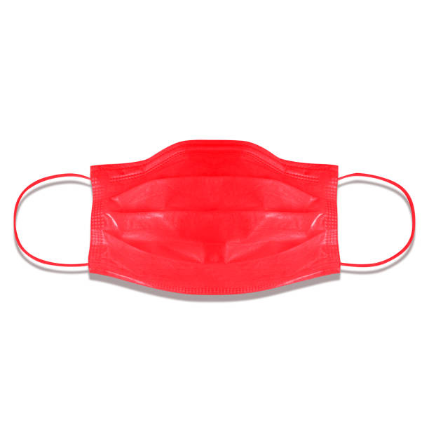 typical 3-ply medical mask isolated on white. hard lighted, harsh shadow. red surgical ear-loop mask. surgical mask with rubber ear straps to cover the mouth and nose. procedure mask from bacteria. - flu virus cold and flu swine flu epidemic imagens e fotografias de stock