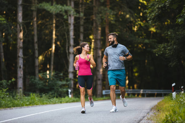 istock Young couple jogging in nature 1211519878