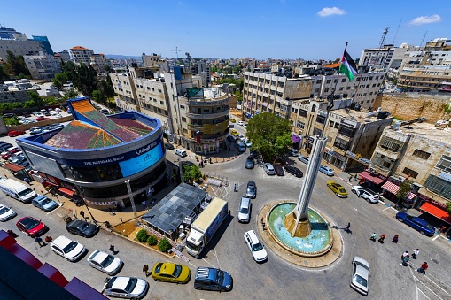 Ramallah, Palestine, May 4, 2019: Aerial view of the Yasser Arafat Square in the city center. The young lad on the monument holding the flag of Palestine near the top symbolizes Yasser Arafat´s dream of liberation of the Palestine.