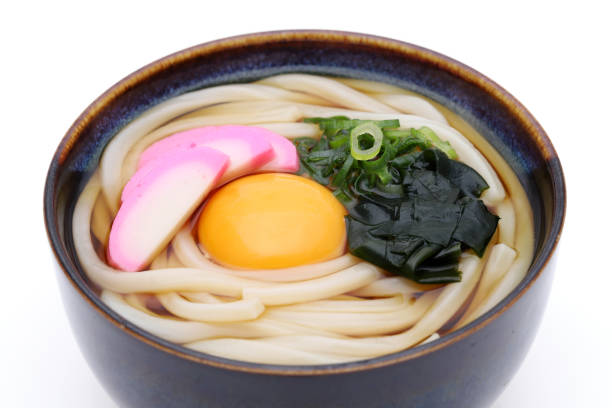 Close up of Japanese Tukimi udon noodles in a bowl on white background