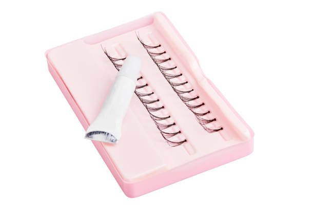 Artificial (false) eyelashes with glue isolated on white Artificial (false) eyelashes with glue isolated on white background. Accessories for eyelash extensions. clump eyelashes stock pictures, royalty-free photos & images
