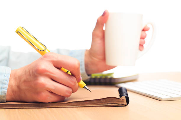 istock female hands write in a notebook . Office place 1211527858
