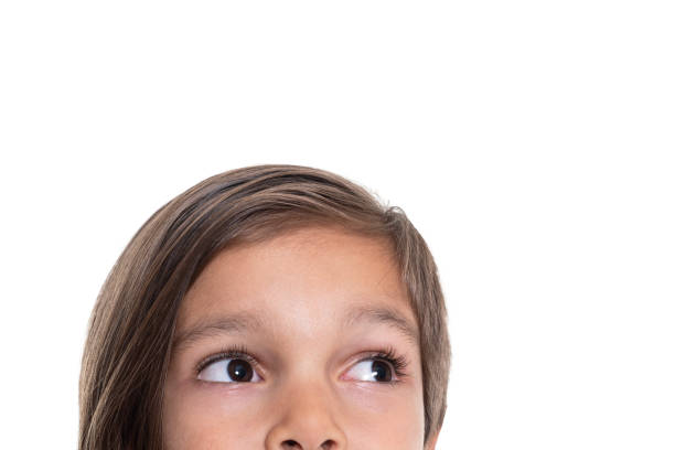 istock Little boy looking up on white background 1211529769