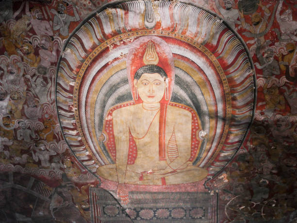 Kandy, Sri Lanka - January 5, 2018: People worshiping Buddha on fresco of the 14th century temple Lankatilaka Vihara with decorated walls on January 5, 2018. Sri Lanka has 245.000 foreign tourists per year