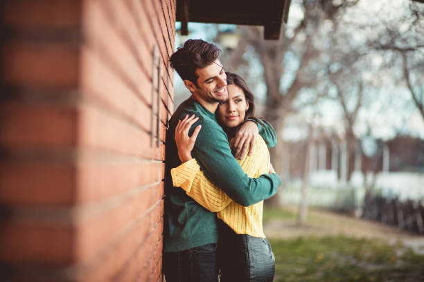 Love opens our eyes to beautiful things. Young happy couple in the park.