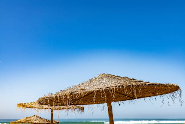 Sunshades at Taghazout, Morocco. Shown against a clear blue sky.