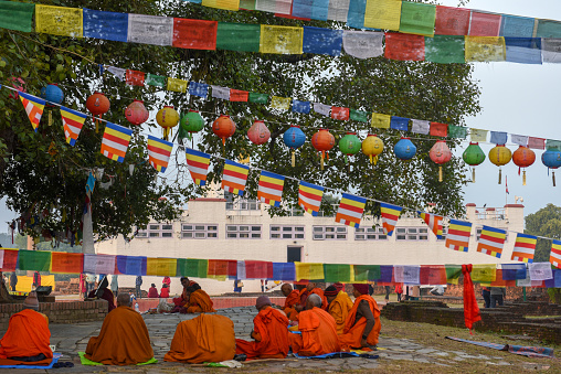 Lumbini, Nepal - 18 January 2020: monks praying at Maya Devi temple birth place of Buddha in Lumbini on Nepal