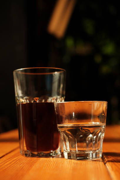 istock Stylish served specialty alternative black coffee. Filter pour-over coffee served in crystal glass and decanter. Aesthetics coffee 1211533298