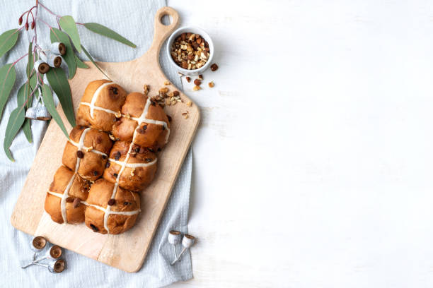 Easter hot cross buns on a serving board.