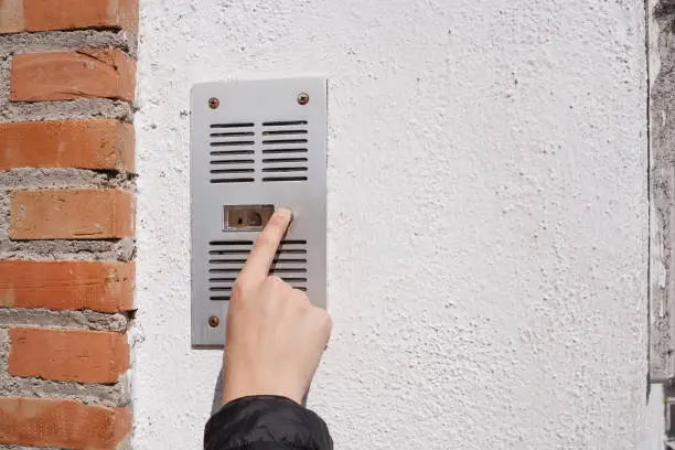 Photo of Woman finger ringing a buzzer.