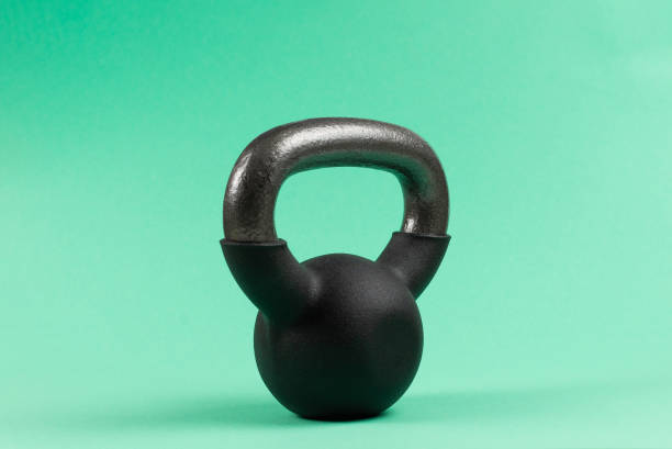 istock Black weight on green background. 4 kg weight. 1211535927