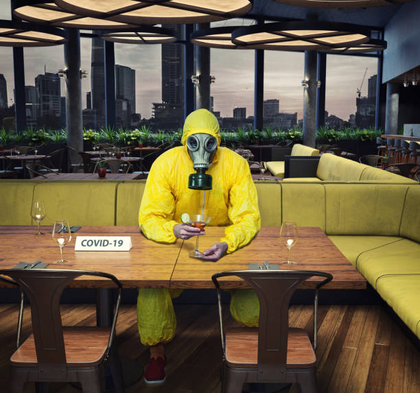 the gas mask man in the cafe interior the gas mask man in the cafe interior. Photo and media mixed  concept restraint muzzle photos stock pictures, royalty-free photos & images