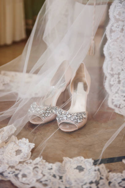 istock Bride's shoes and veil 1211537477