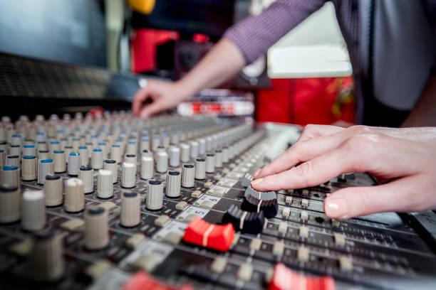 istock Music engineers working together in recording studio using mixing desk 1211539734