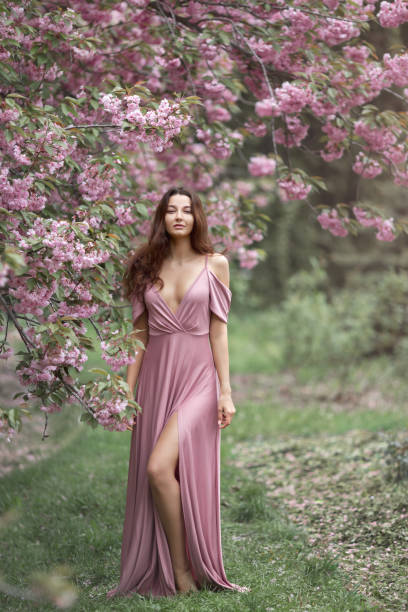 istock Woman at Blossoming Sakura Tree on Nature 1211539800