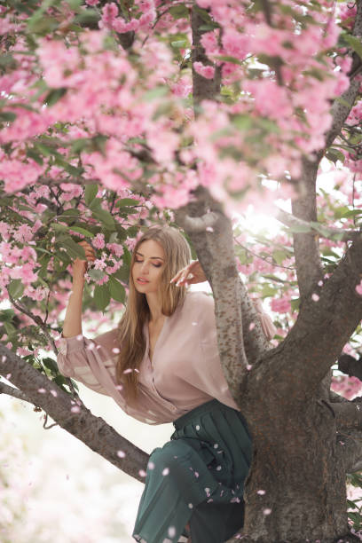 istock Woman at Blossoming Sakura Tree on Nature 1211540045