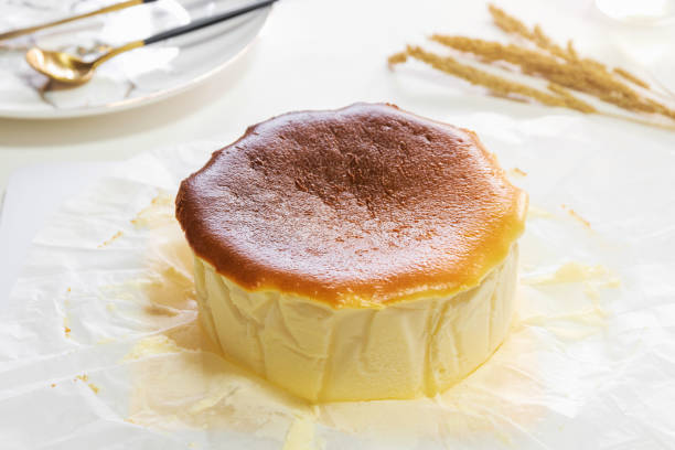 istock Pound of Basque Burnt Cheesecake on white baking paper. 1211540297