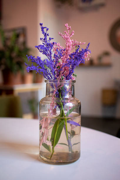 istock Vase with colored flowers on the table 1211540562
