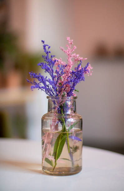 istock Vase with colored flowers on the table 1211540573