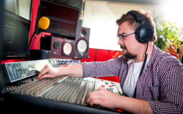 istock Sound producer working at recording studio using soundboard and monitors 1211541146