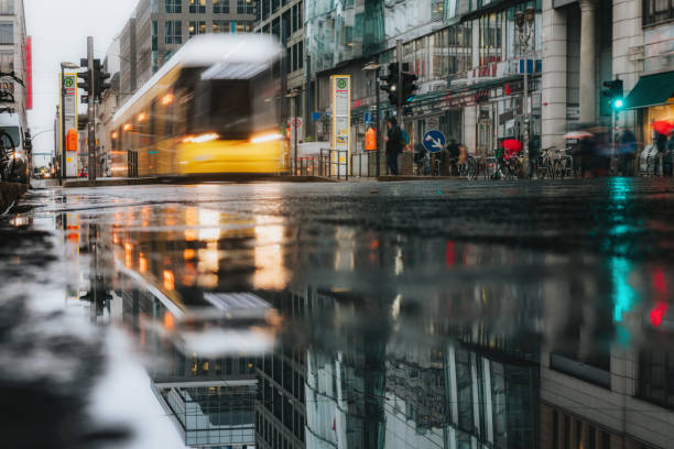 istock yellow tram reflecting in puddle 1211541231
