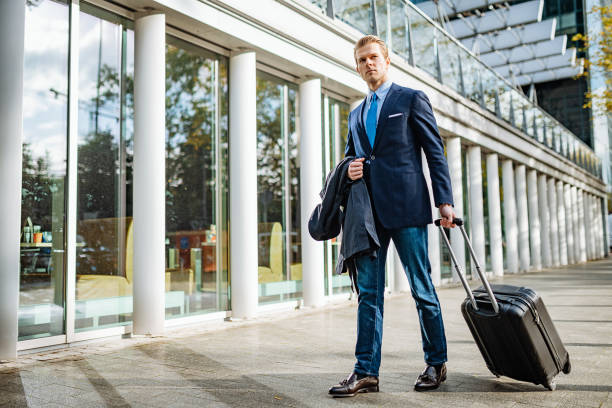 istock Modern businessman traveling with suitcase 1211542539