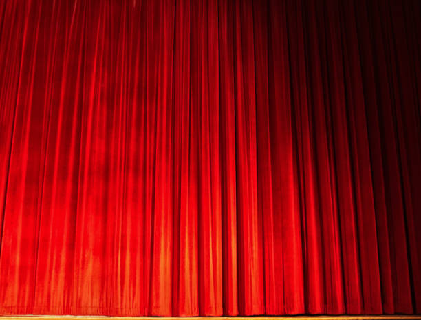 Bright red velvet stage drape A theatrical stage curtain of bright red velvet, closed. curtain call stock pictures, royalty-free photos & images