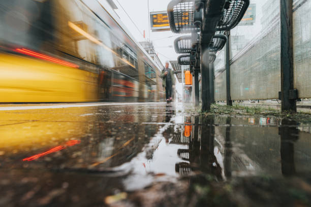 long exposure of yellow tram coming to station Berlin Friedrichstrasse on rainy monday