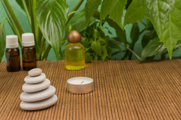 istock Candle and spa stones, green leaves. SPA relaxation concept. 1211542840