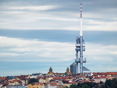 Prague, Czech Republic - October 1, 2019: The Prague TV tower Zizkov is one of the most impressive sights of Prague. This is due to the size of the tower alone, which at 216 meters easily trumps all other buildings in the city. It can be walked on and is therefore ideal for getting an overview of the city as a tourist on the first day in Prague. the “babies” by artist David Černý have populated the pillars of the Prague TV tower since 2000.