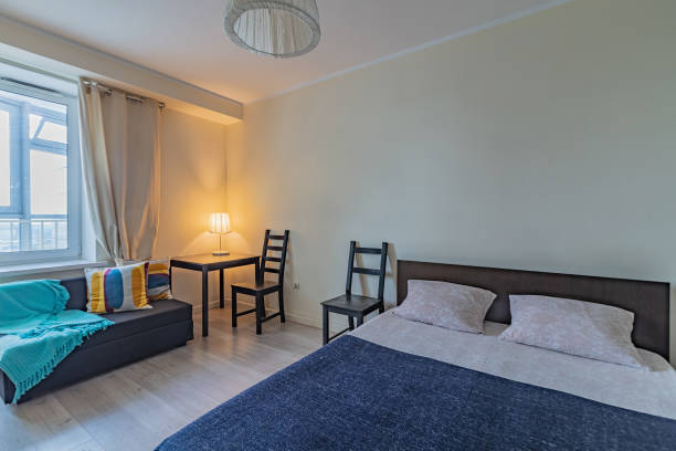 istock rental apartment with bed chairs sofa and table 1211544271